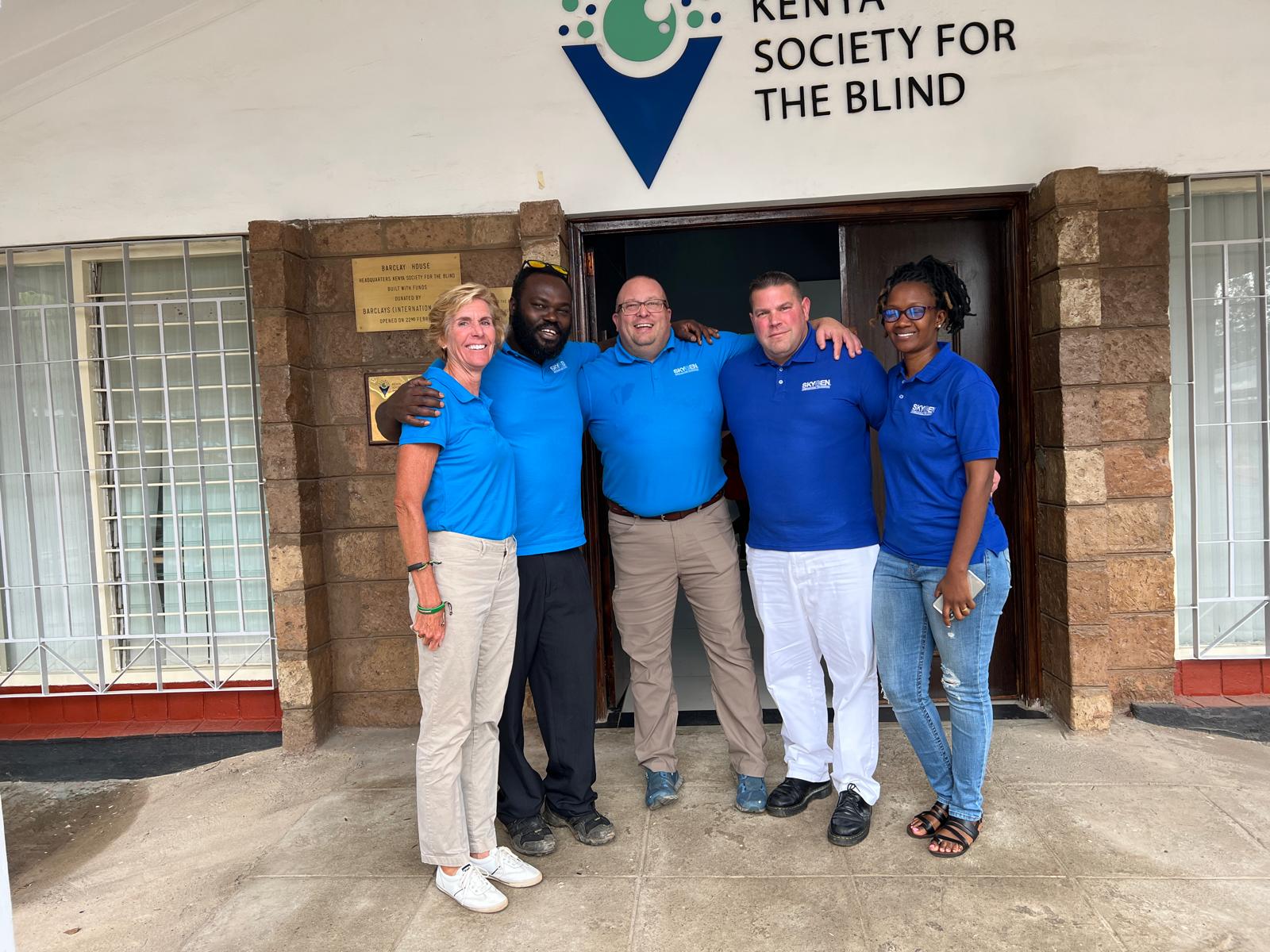 A five-person regional health team standing outside the Kenya Society for the Blind