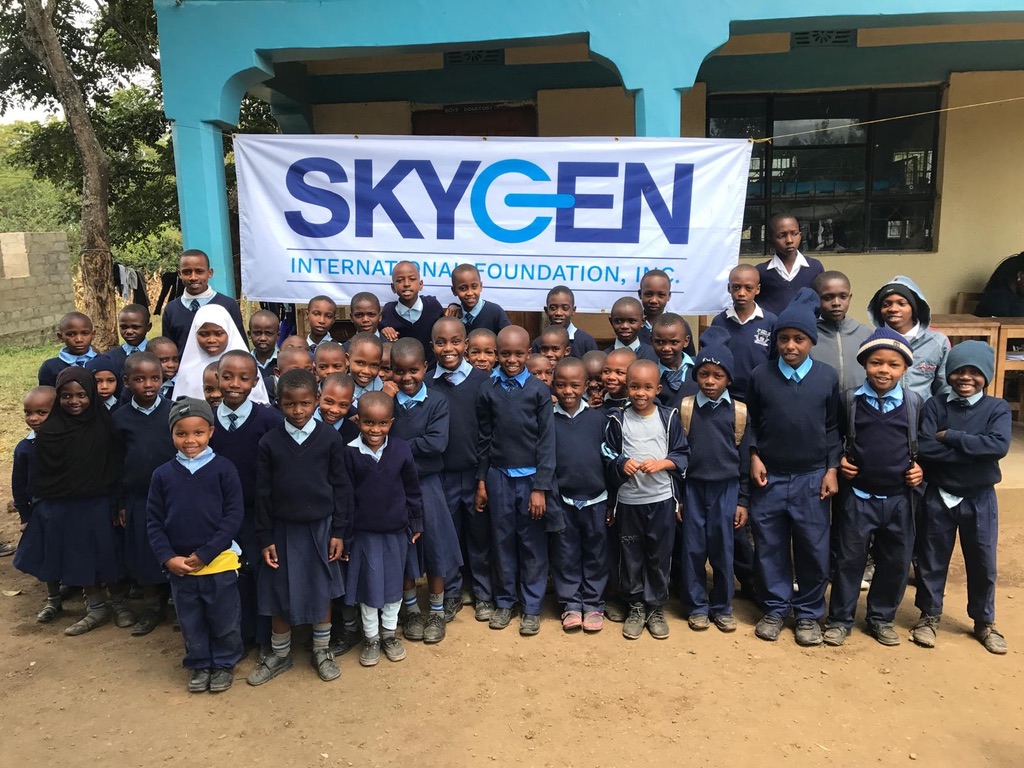 A group of schoolchildren gathered outside during a school health outreach visit
